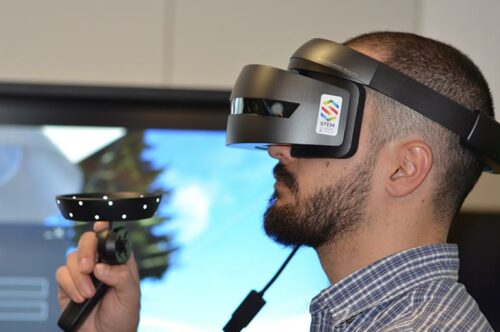 Man Using VR Headset And Control Stick For Elearning