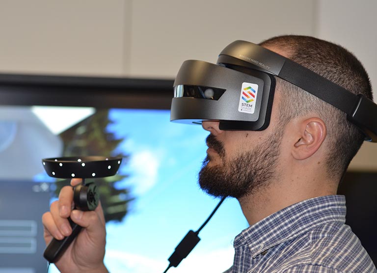 Man using VR headset and control stick for elearning