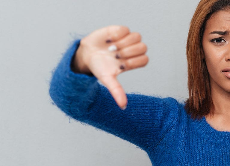 Woman showing a thumbs down gesture